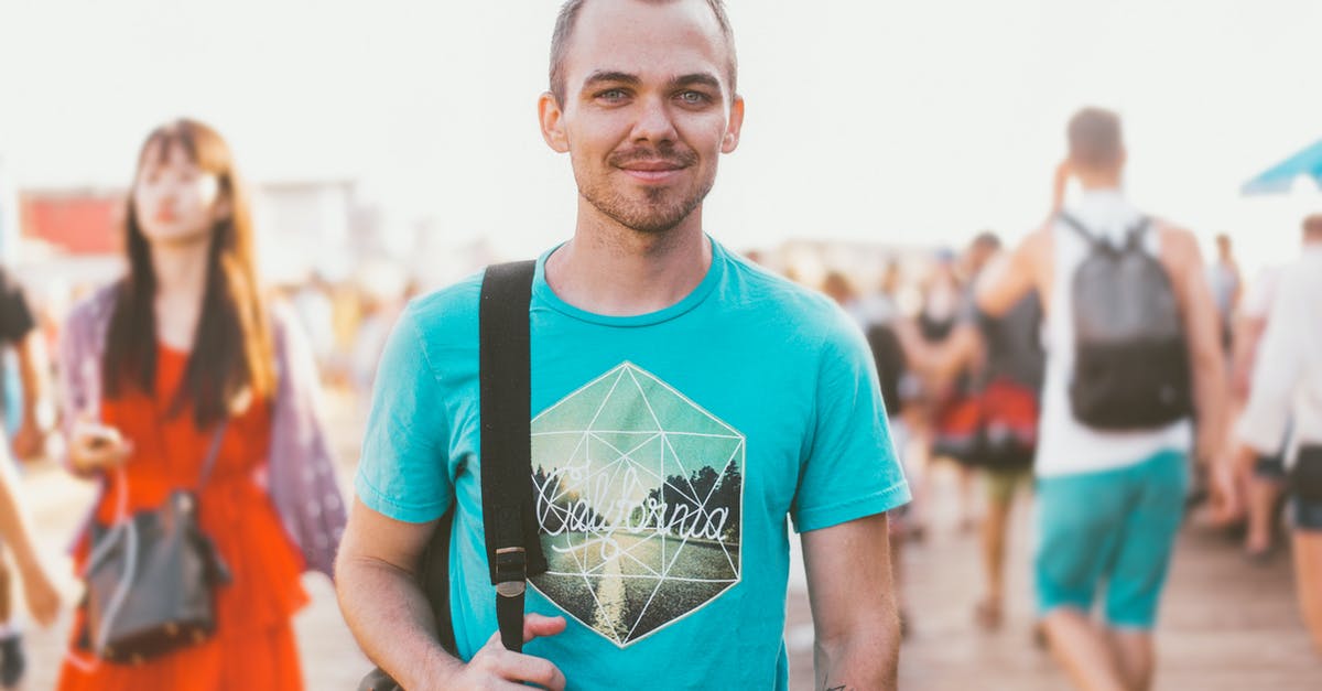 Tattoos while Traveling Overseas - Man Holding Black Bag