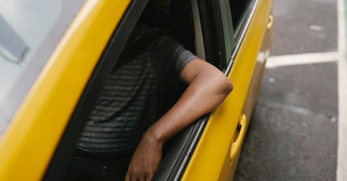 taxi from gare du nord, Paris to avenue lamotte-piquet? [closed] - From above of crop anonymous ethnic male working in taxi in modern city