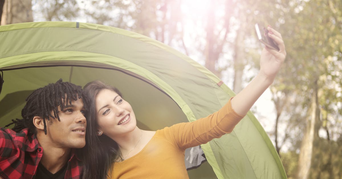 Tent in hand luggage? - Man and Woman Taking Selfie Using Smartphone