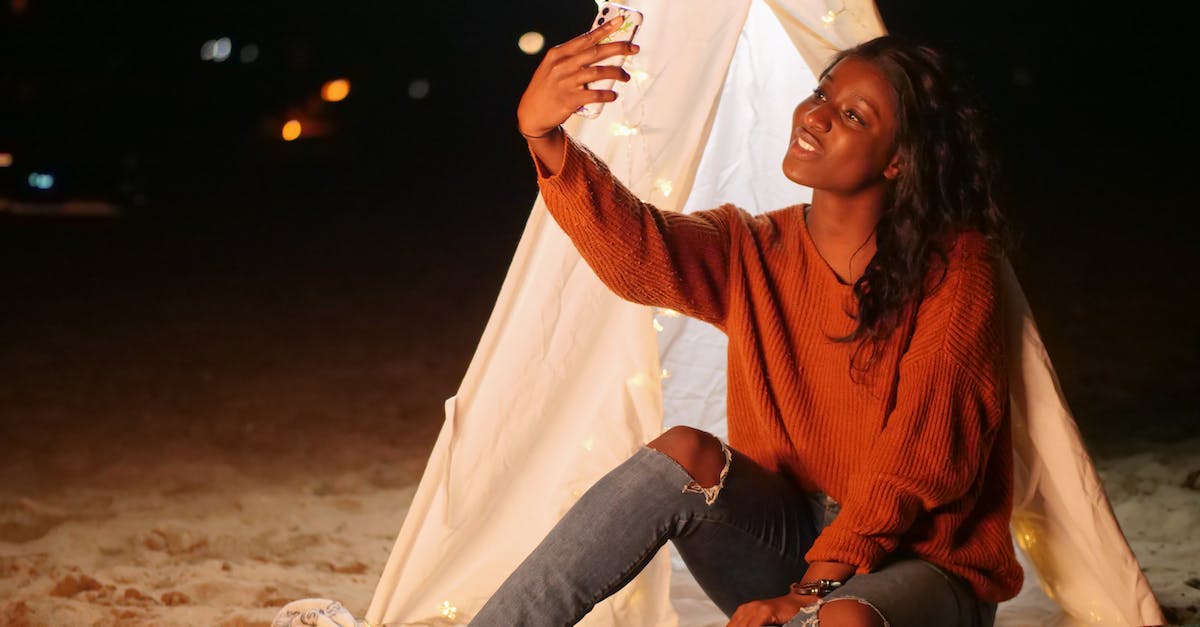 Tent in hand luggage? - Woman Leaning on a White Teepee Taking a Selfie