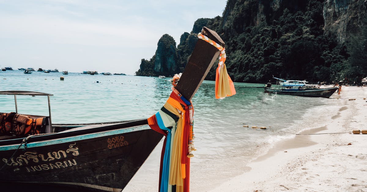 Thailand visa on arrival. How long does it take to get it? - Long tail boat on sandy seashore in tropical resort