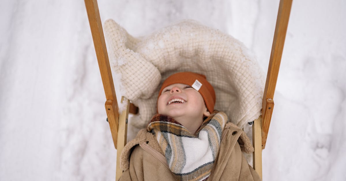 The Atomic Testing Museum: Suitable for small children? - Baby in Brown Coat Lying on White and Blue Textile