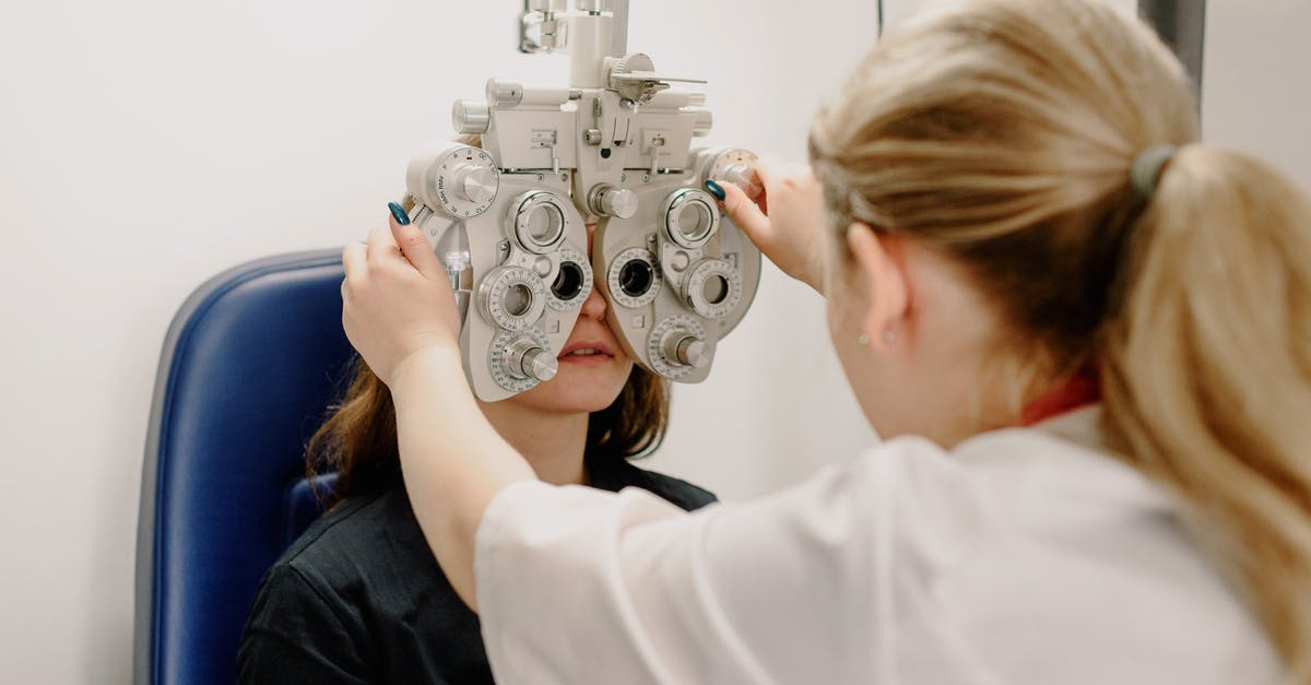 The UK's "instant" passport service ... how long currently to appointment? - Unrecognizable ophthalmologist checking vision of patient