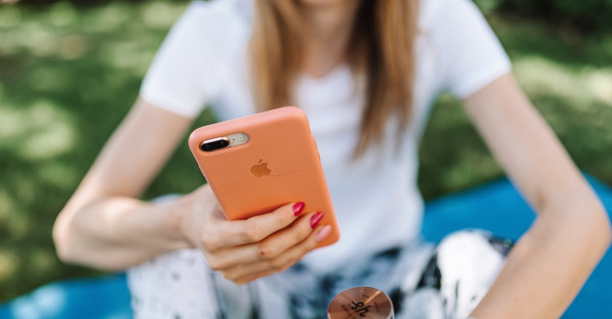 The using of VPN on iPhone in China [duplicate] - Close-Up Photo of a Woman Using Her Iphone