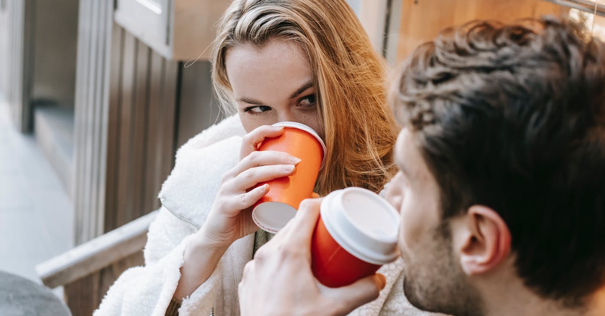 thermal (hot springs) destinations in Europe for young couples [closed] - Young couple drinking hot beverages and looking at each other in cafe