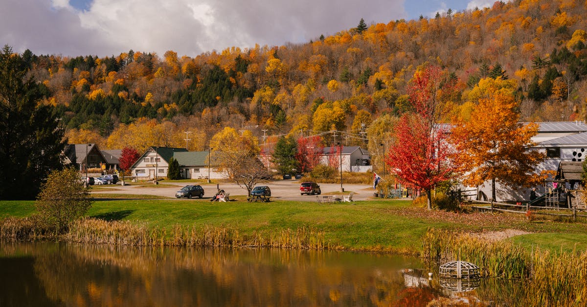 Things to do before shipping a car across the country - Rural houses in autumn day on shore of pond