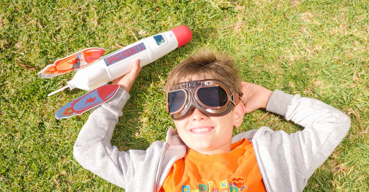 Things to do with young children in Paris in August - Boy in Gray and Orange Hoodie Wearing Black Sunglasses