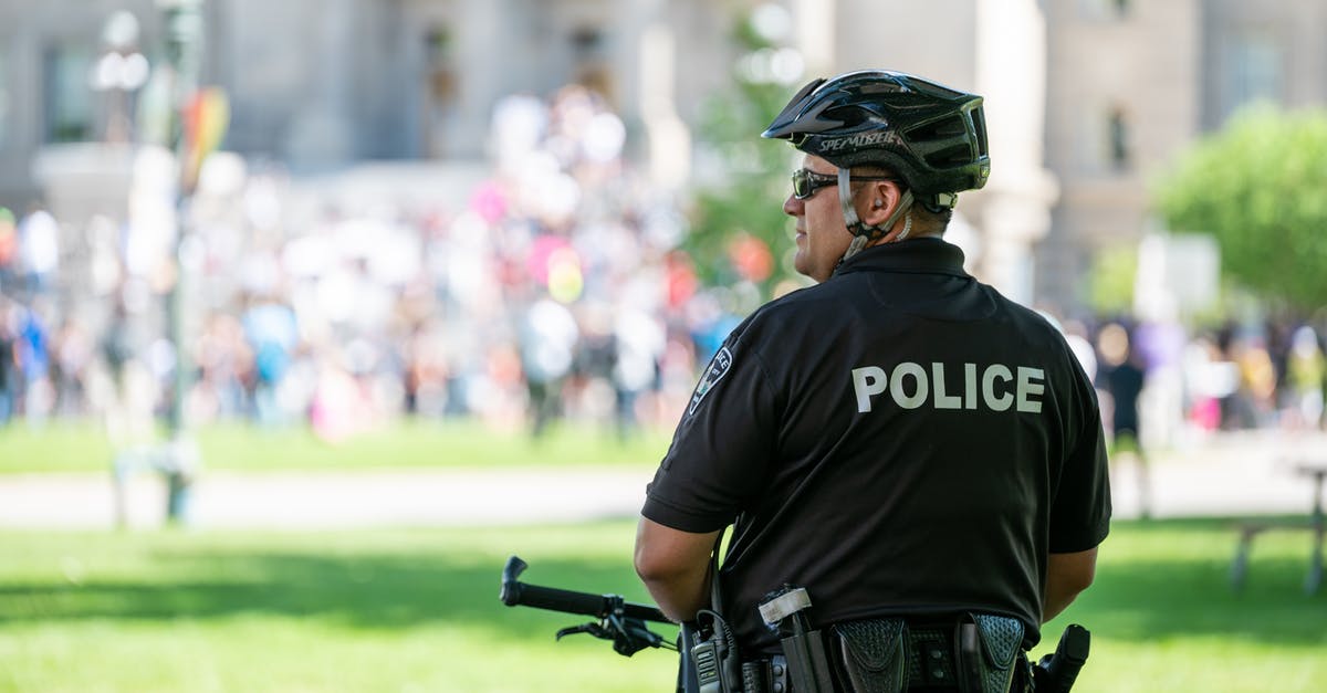 Things to see by bicycle in the Camargue [closed] - Police officer on bicycle standing in front of protesting crowd