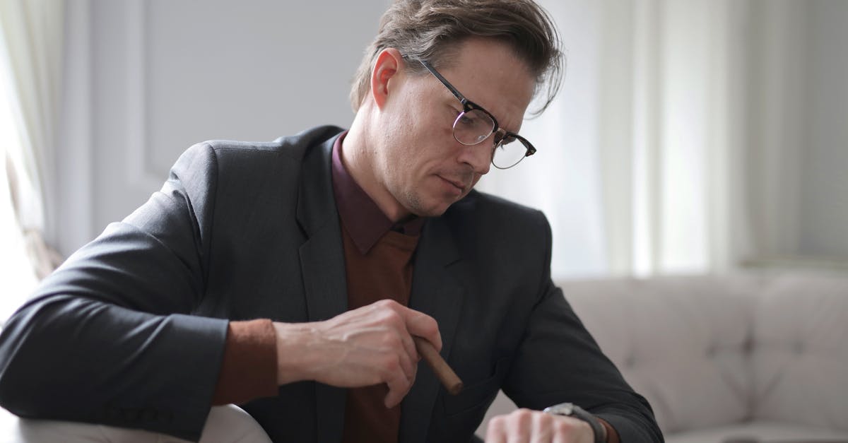 Third time visa refusal [duplicate] - Photo of Man in Black Suit Sitting on White Couch Smoking a Cigar While Looking at the Time