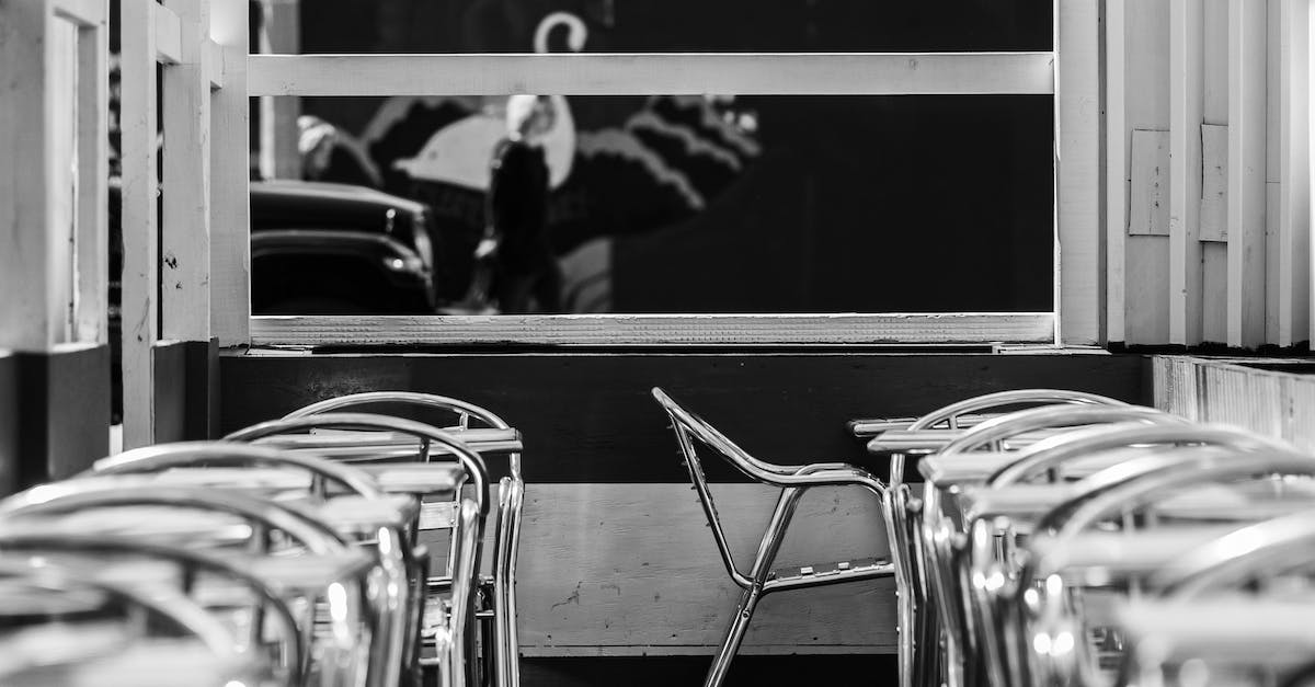 Tipping in NYC restaurants - Black and White Photo of Chairs 