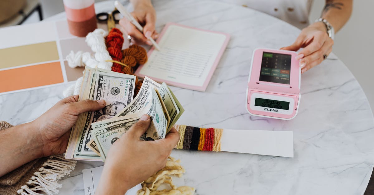 Tipping in the US when paying in advance - Hands Holding US Dollar Bills