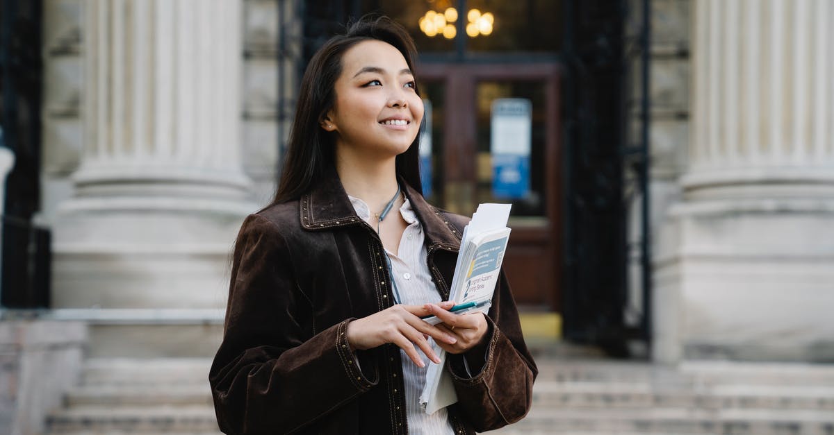 TLS Contact Scanned documents for Student Schengen Visa - A Woman in Brown Coat Holding Documents