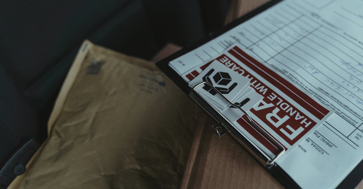 TLScontact Travel Document returned by courier - White and Black Box on Brown Wooden Table