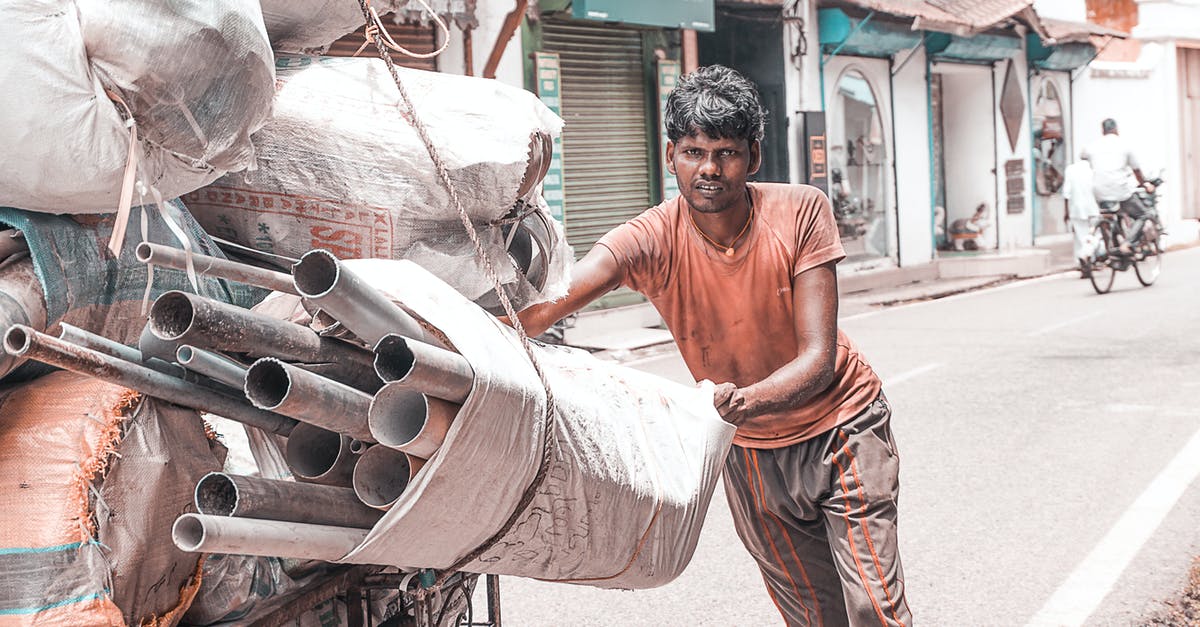 Too many countries to apply for Indian E-Visa? - Man Holding White Sack Filled With Pipes