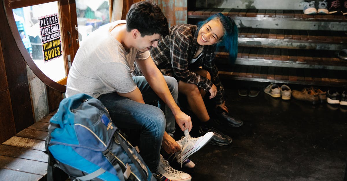 Tourist to F1 change of status within 60 days [closed] - Cheerful ethnic couple putting on sneakers