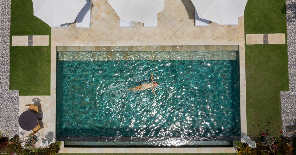 Tourist visa Schengen Zone [duplicate] - Drone view of anonymous female tourist relaxing in pool water near terrace with white parasols among green lawns in comfortable hotel zone during vacation