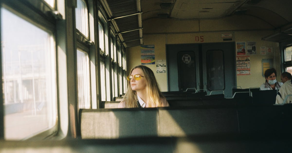 Train + rental car as alternative to air travel inside Europe - Pensive woman looking at window of train