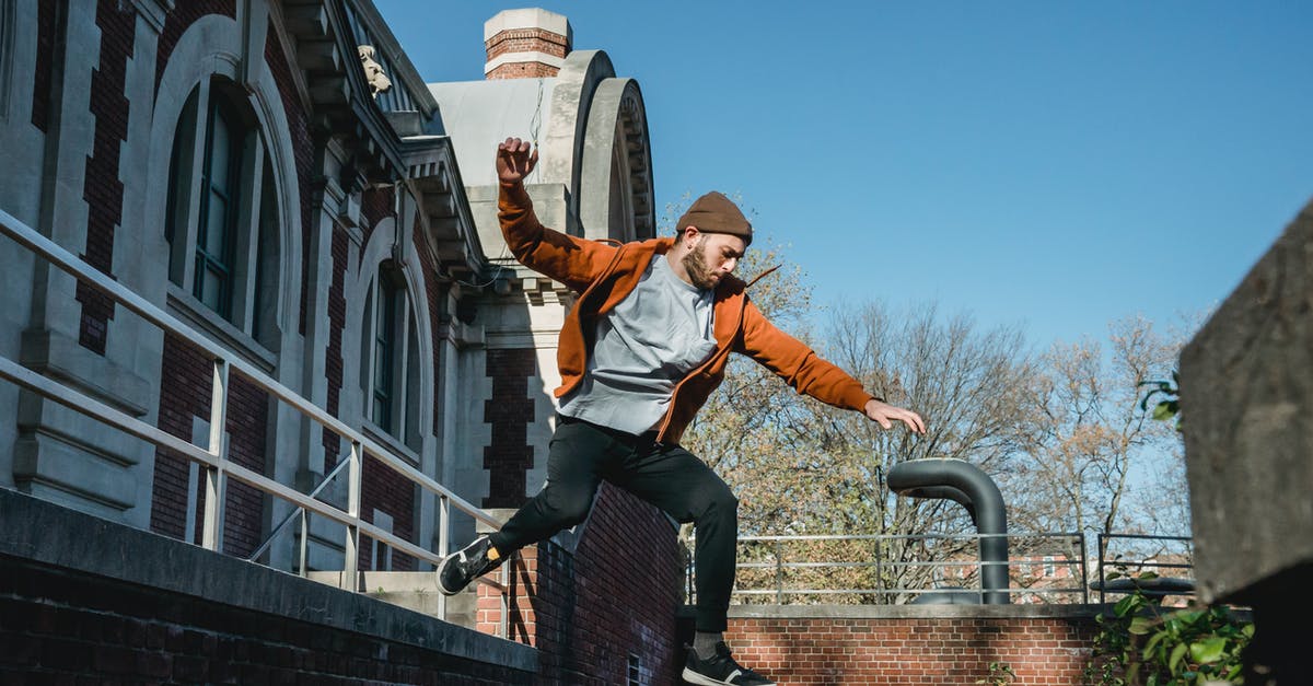 Train from Nice to Moscow / Border Controls - Energetic man jumping from wall in town