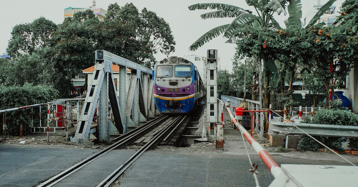 Trains in Vietnam - Blue and White Train on Rail Road