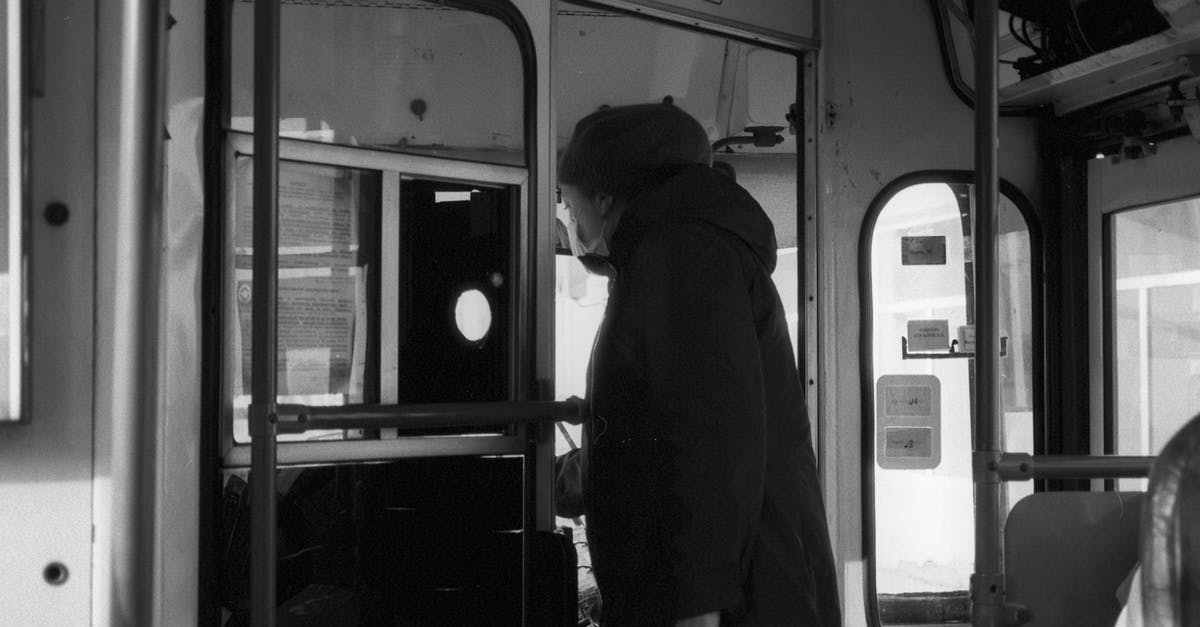 Tram tickets in Bonn - Man in Black Jacket Sitting on Train Seat