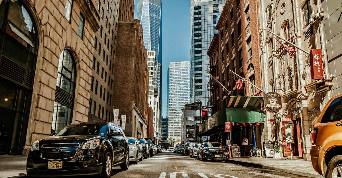 Transfer from LGA to JFK with a stop in Manhattan - Vehicles on Road Between Buildings