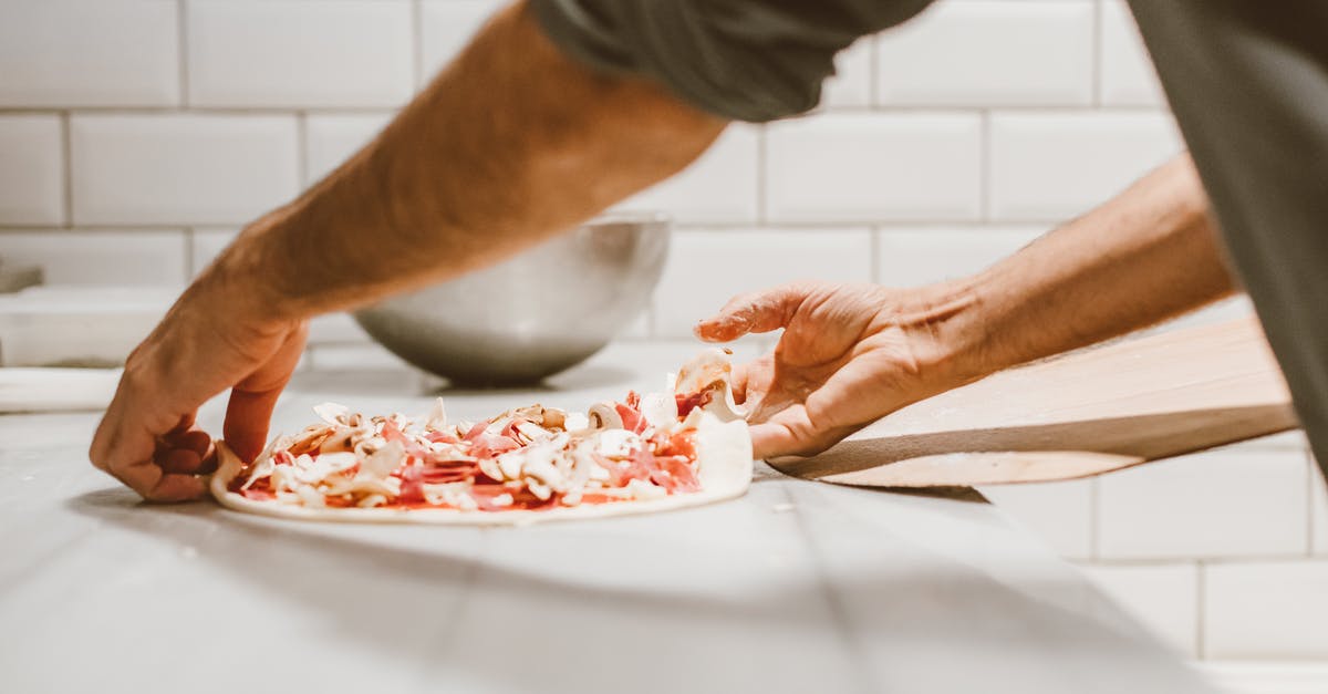 Transferring between airports in Oslo (Norway) [closed] - Person Transferring the Pizza Dough on a Wooden Paddle