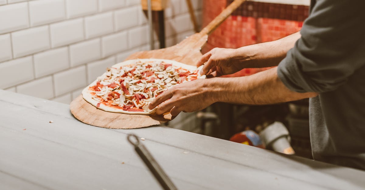 Transferring between airports in Oslo (Norway) [closed] - A Person Putting the Pizza Dough on a Wooden Paddle