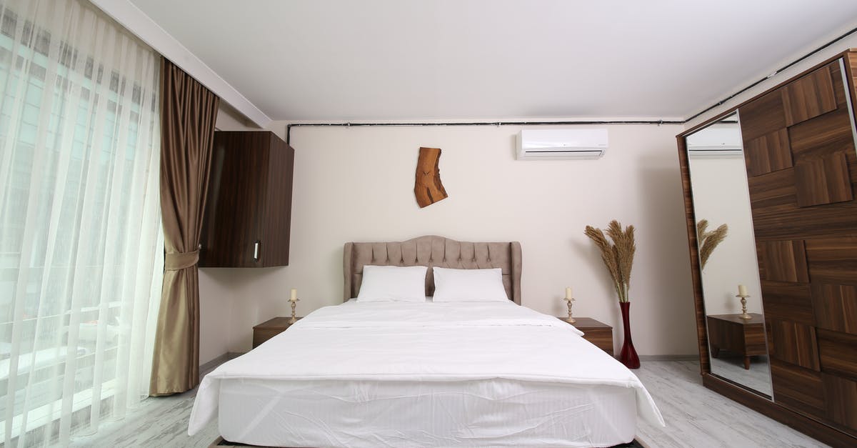 Transit hotel and visa at Istanbul - White Bed Linen With Brown Bed Frame