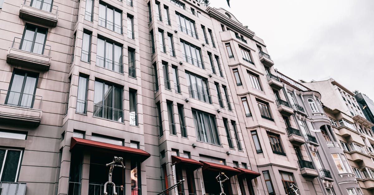 Transit hotel and visa at Istanbul - From below of contemporary residential building decorated with figures located on street of Istanbul