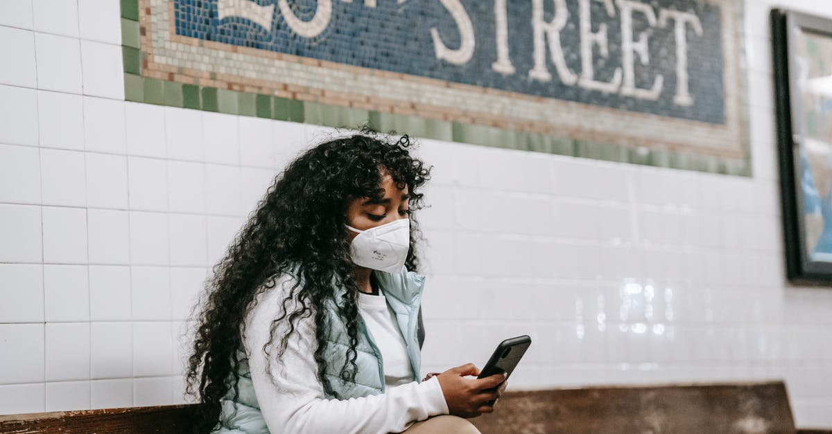 Transit in LA after 90 days in North America under VWP/ESTA - Focused black woman using smartphone in underground station Transit in LA after 90 days in North America under VWP/ESTA - Focused black woman using smartphone in underground station