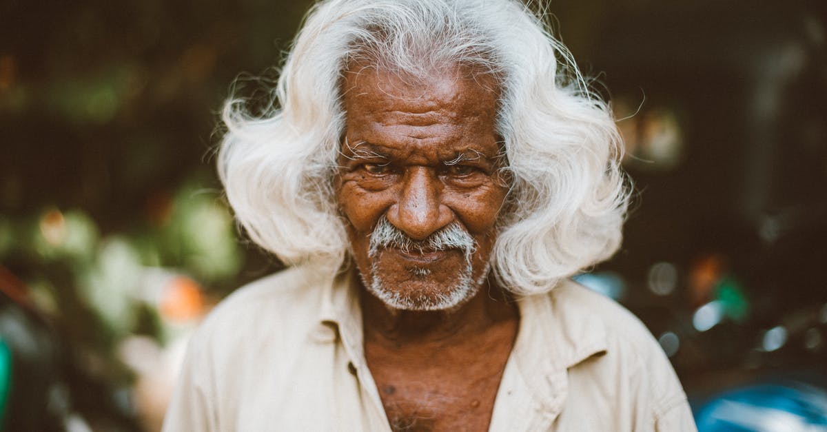 Transit visa for Indian citizen traveling through Hong Kong - Optimist elderly ethnic man on urban street