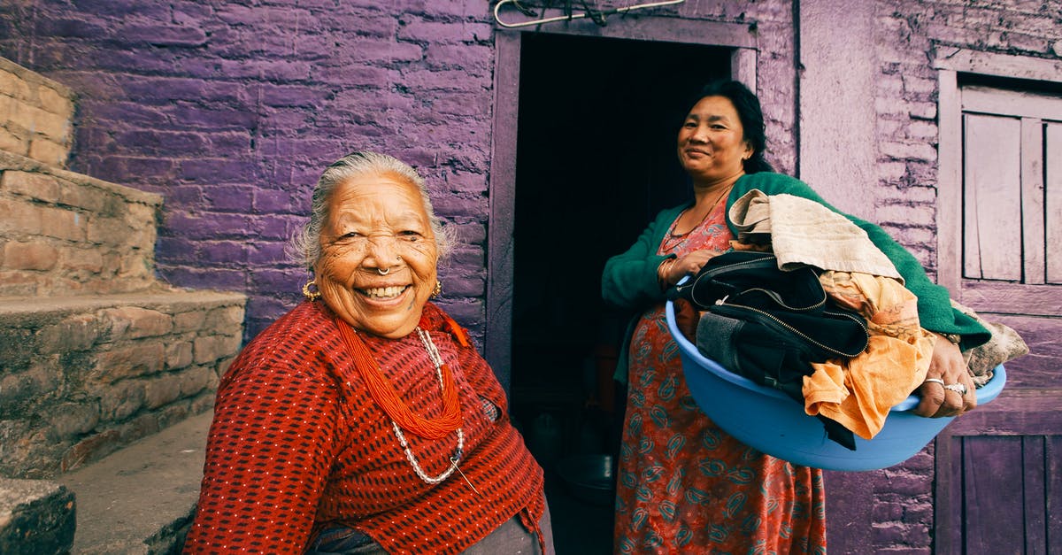 Transiting through Turkey two days before passport expires - Two Women Posing in Front of Slum Violet House