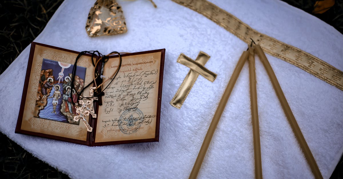 Translating a translated birth certificate - From above of white towel with golden cross and candles with birth certificate and crosses