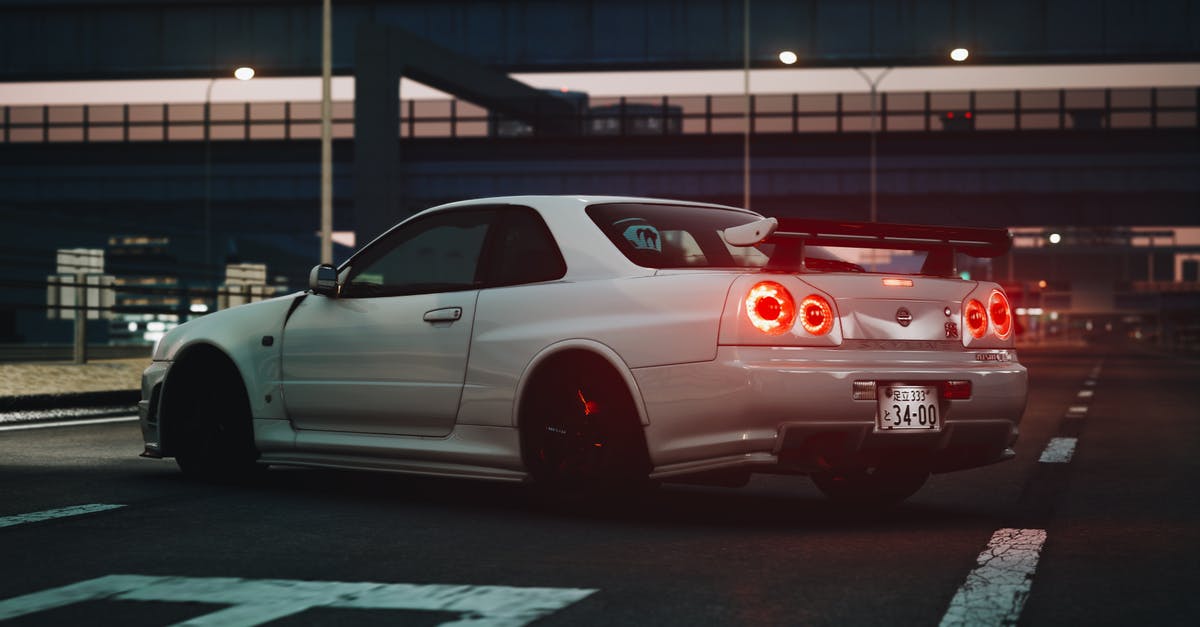 Transportation in Miyazaki Japan - A White Nissan Coupe Car Parked on the Road