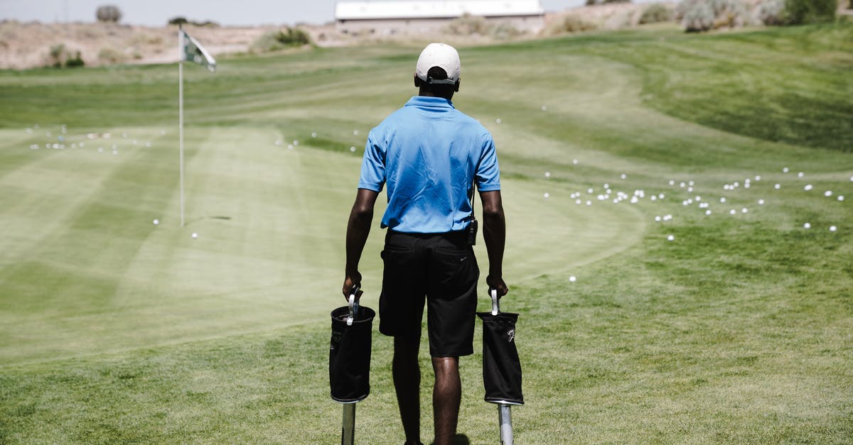 Transporting Golf club shafts - Man in Blue Polo Shirt Carrying Black Bags