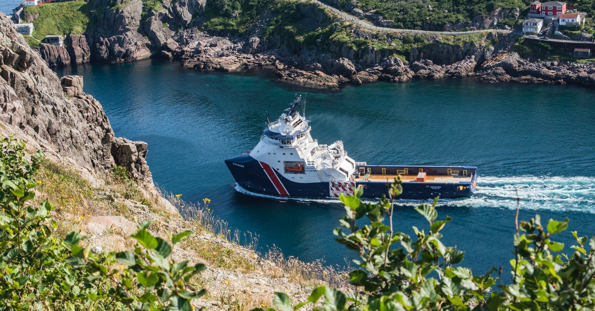 Travel by ship from India to Canada - White and Blue Boat on Body of Water