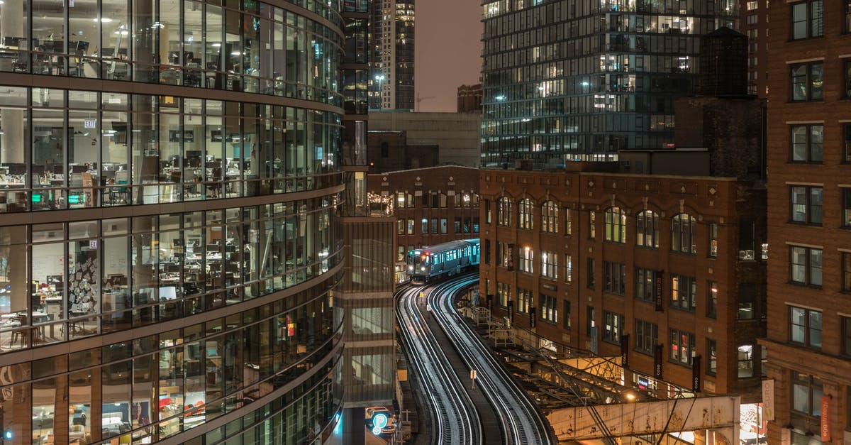 Travel from dusseldorf to UK by Train [duplicate] - Exteriors of modern illuminated glass buildings in downtown at night