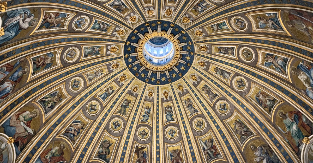 Travel from Europe to Asia tickets - From below amazing dome ceiling with ornamental fresco paintings and stucco elements in St Peters Basilica in Rome