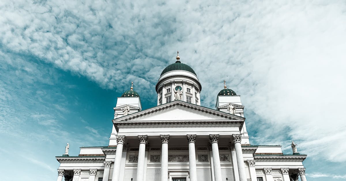 Travel from the UK to Finland with a Spanish Schengen visa - Majestic white cathedral with domes and pillars against blue sky