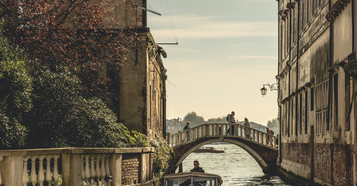 Travel from Venice, Italy to Cologne, Germany - White Concrete Bridge Between Houses