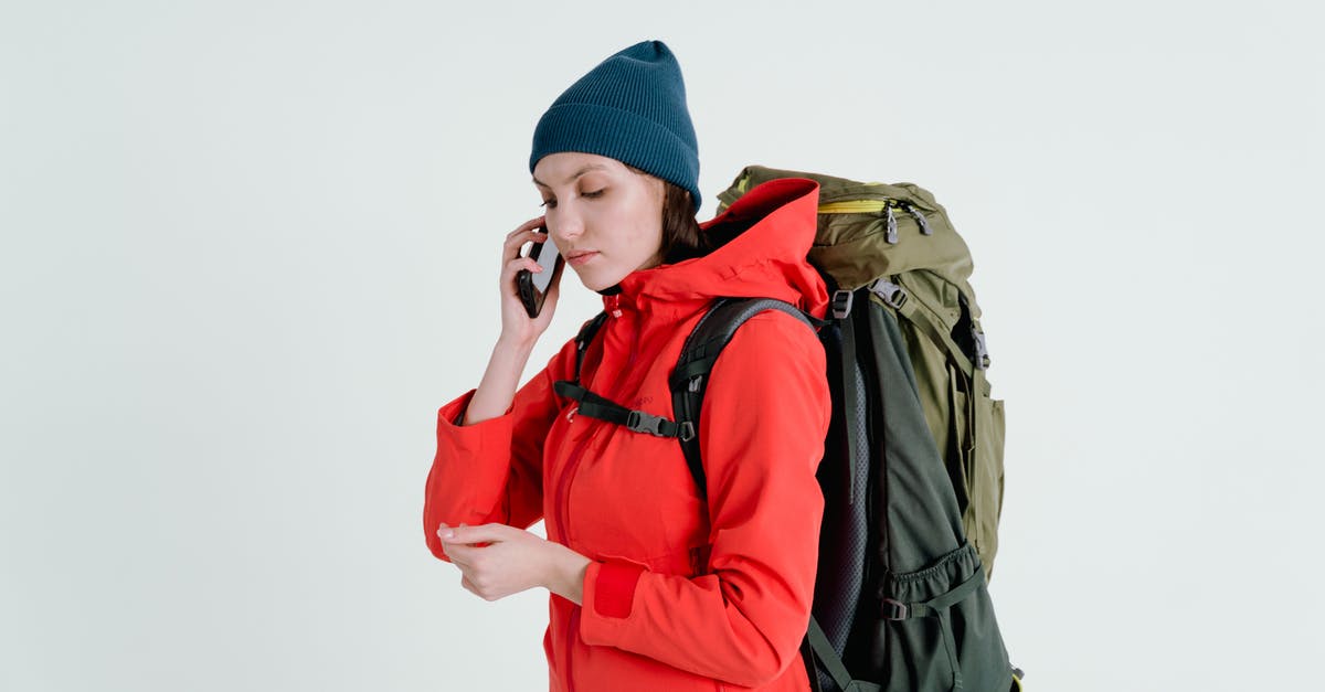 Travel in Scandinavia during autumn - Woman in Red Jacket and Blue Knit Cap