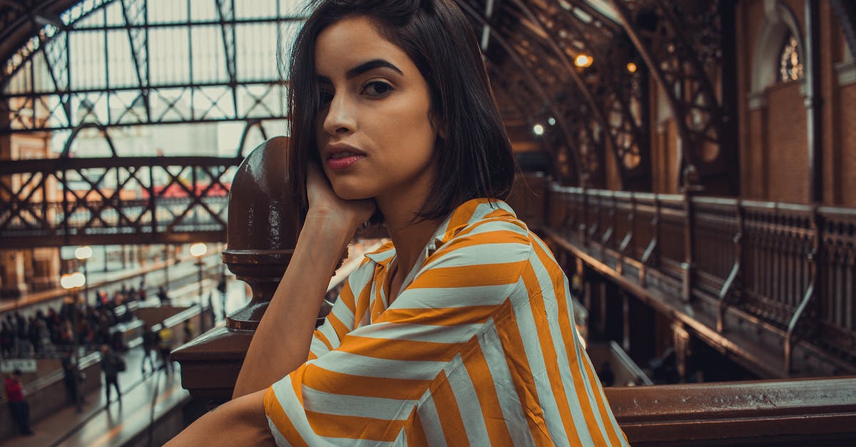 Travel insurance for very short missed connection - Woman Leaning on Railings in Subway Station