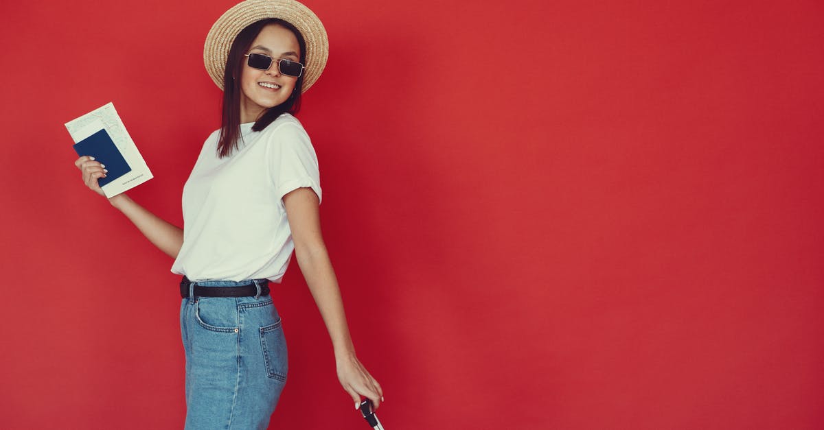 Travel on Short/Visit on Schengen Visa with separate tickets - Smiling young female with luggage and passport on red background