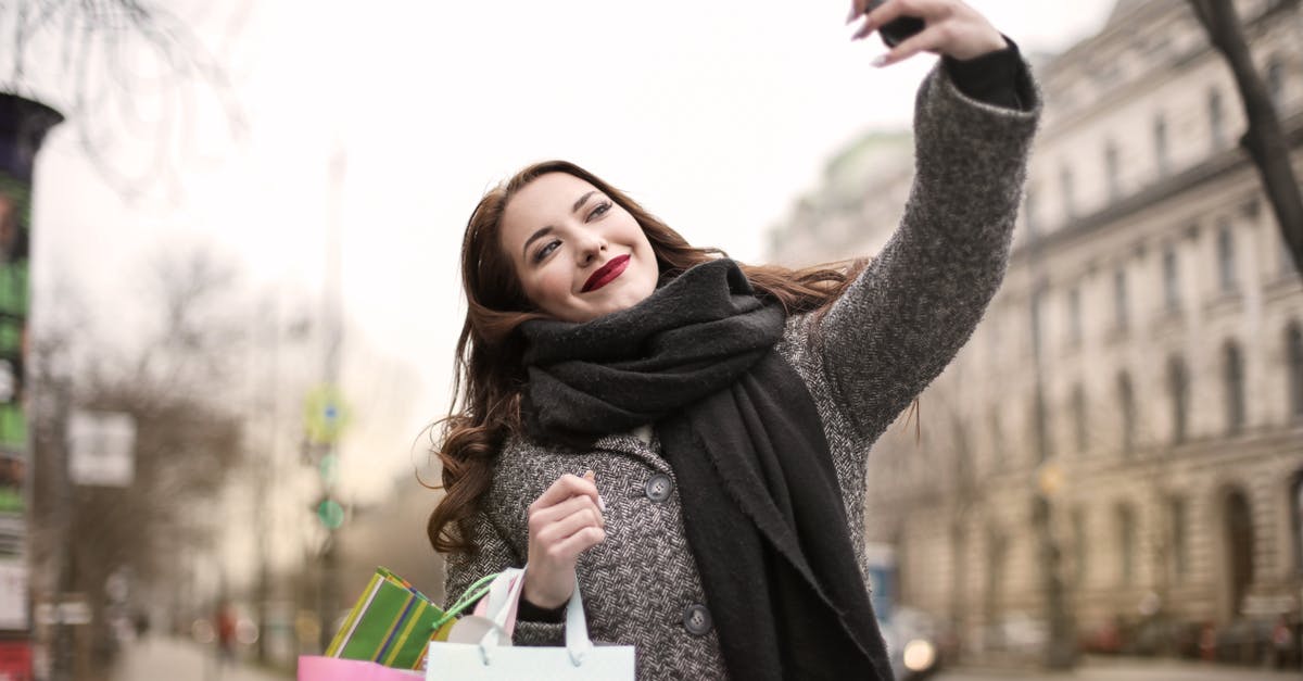 Travel, shopping electronics (for private use) - Woman Taking a Selfie Using Smartphone