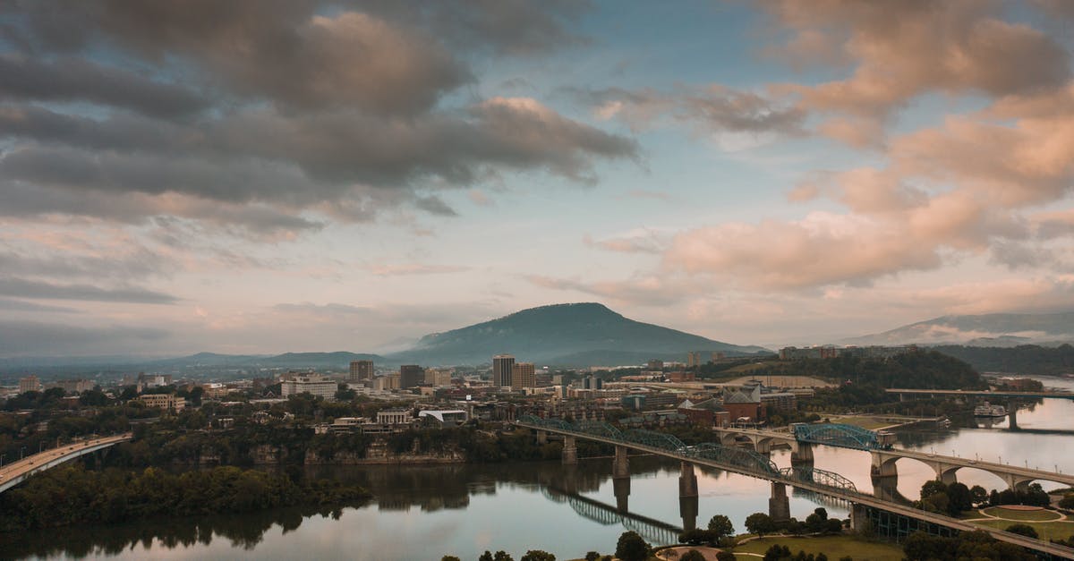 Travel to US - PCR or lateral flow? - Picturesque scenery of modern bridges over Tennessee River flowing in Chattanooga city against cloudy sundown sky