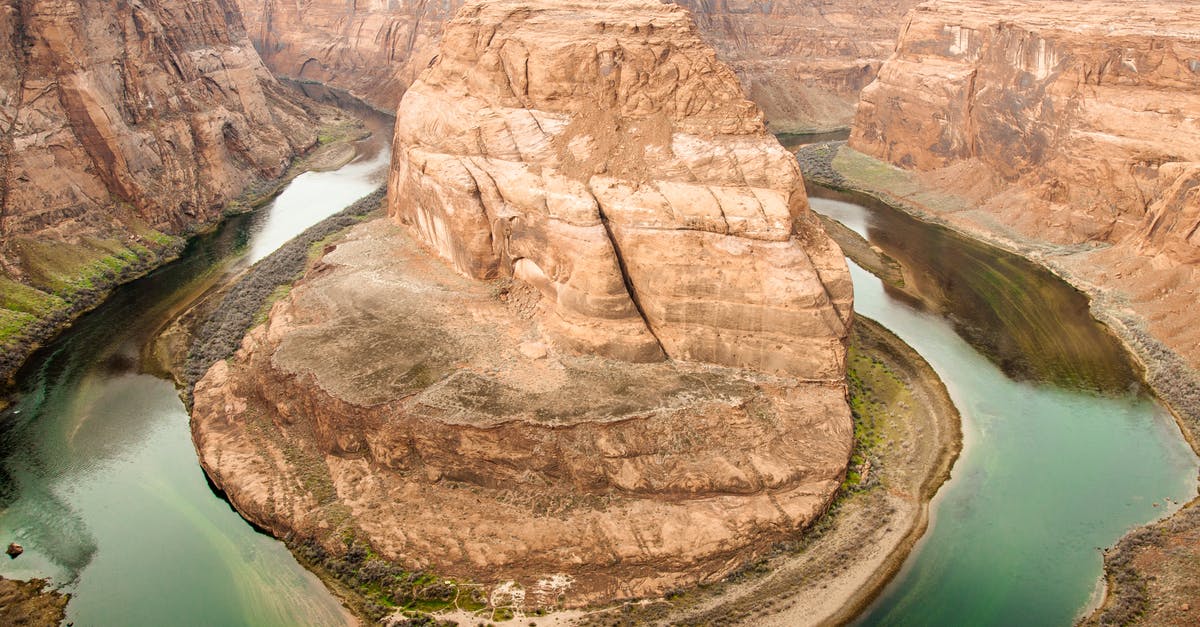 Travel to US - PCR or lateral flow? - Picturesque view of rough rocky terrain of Horseshoe Canyon and calm green river flowing between rocky slopes in Canyonlands National Park in Utah