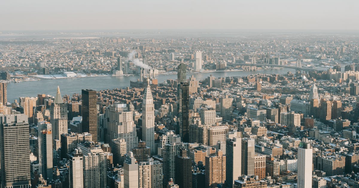 Travel to US while working for US business - Spectacular drone view of New York City skyline with modern skyscrapers and towers near Hudson River on sunny day