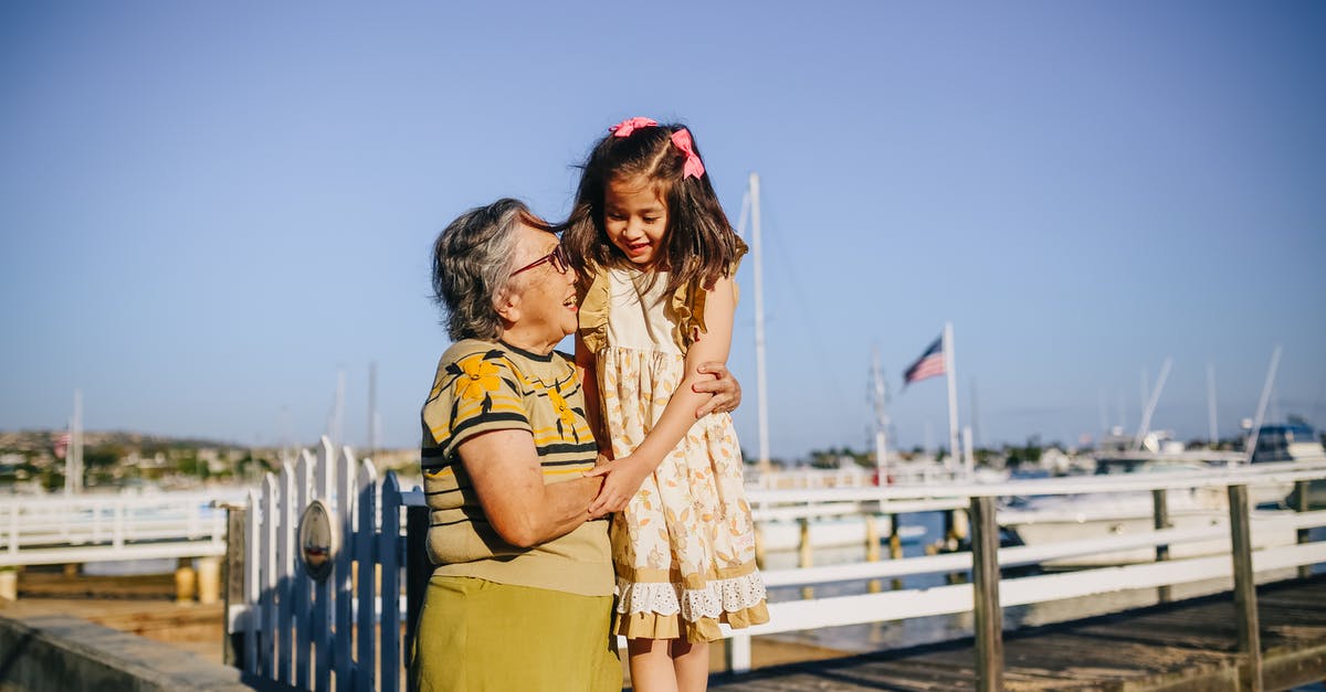 Travel with an 3 years old children in Disneyland Paris [closed] - Grandma with Her Granddaughter Standing on the Shore