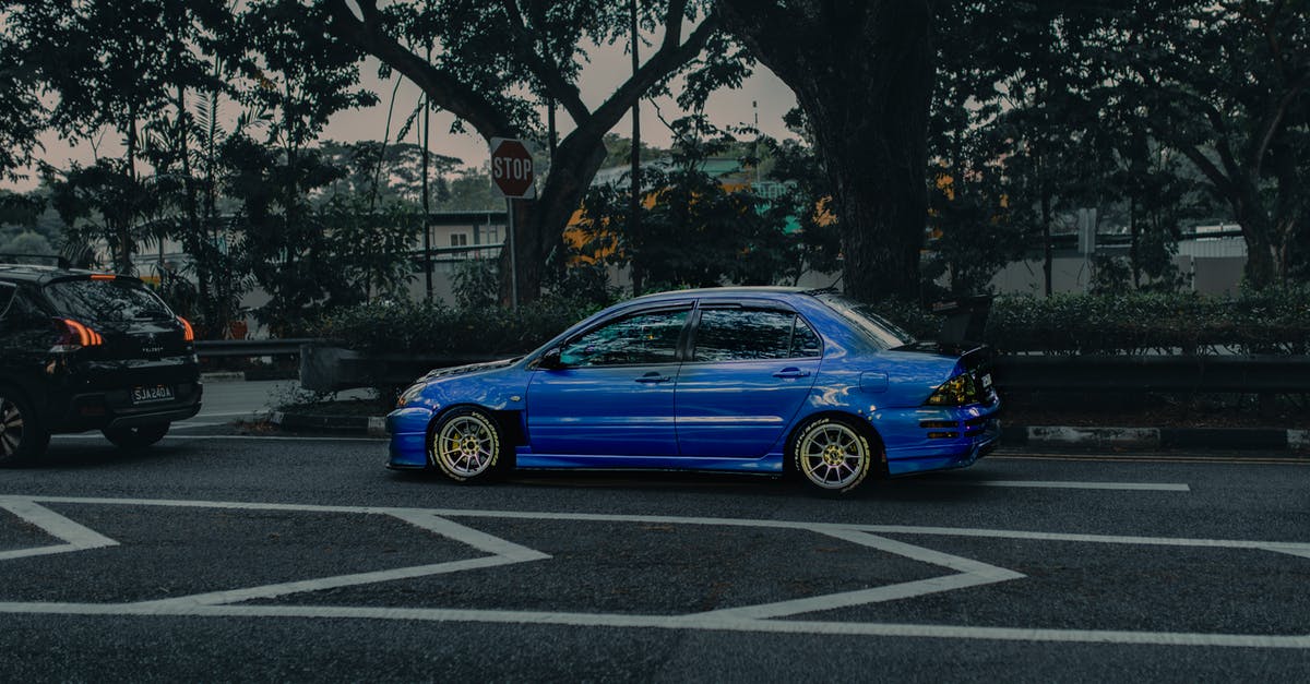 Travel (with public transportation) in New England [closed] - Modern blue car on asphalt road