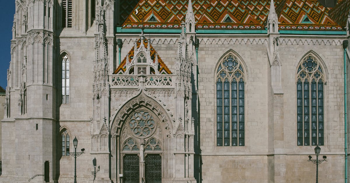 Traveler's Century Club: Something similar just for Europe? - Exterior of Matthias Church with ornamental windows and colorful roof on street in sunny day